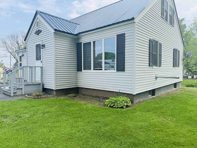 10 Laurette Cir, Caribou, ME 04736 - view of side of home with a yard and metal roof