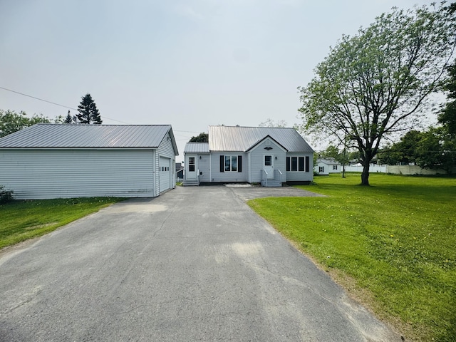 10 Laurette Cir, Caribou, ME 04736 - view of front of home with a front lawn, an outdoor structure, metal roof, a garage, and entry steps