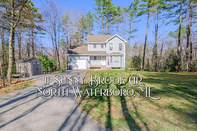 11 Sunny Brook Cir, Waterboro, ME 04061 - traditional-style house with an outdoor structure, a garage, a front lawn, aphalt driveway, and a storage unit