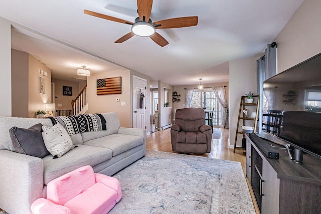 11 Sunny Brook Cir, Waterboro, ME 04061 - living room with a ceiling fan, stairway, and light wood finished floors