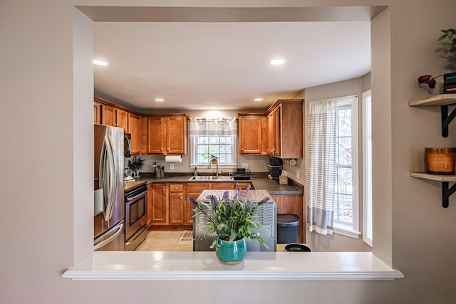 11 Sunny Brook Cir, Waterboro, ME 04061 - kitchen with brown cabinets, dark countertops, a sink, stainless steel appliances, and recessed lighting