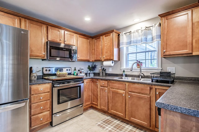 11 Sunny Brook Cir, Waterboro, ME 04061 - kitchen featuring a sink, dark countertops, brown cabinetry, and stainless steel appliances