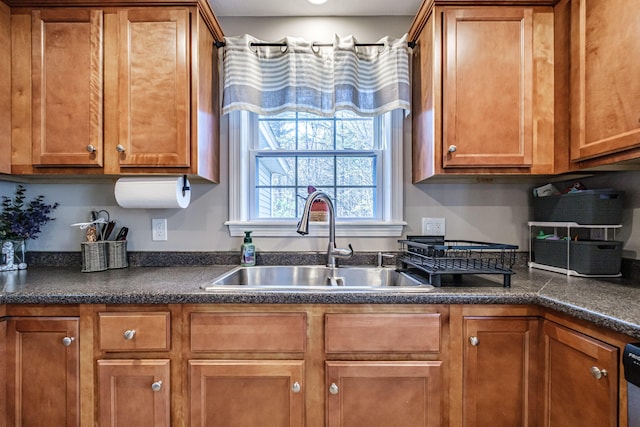 11 Sunny Brook Cir, Waterboro, ME 04061 - kitchen featuring a sink, dark countertops, and brown cabinetry