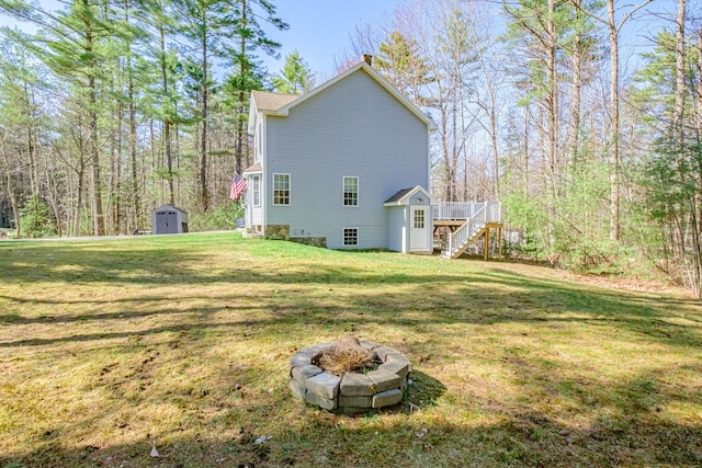 11 Sunny Brook Cir, Waterboro, ME 04061 - rear view of property featuring a chimney, an outbuilding, stairway, a shed, and a fire pit