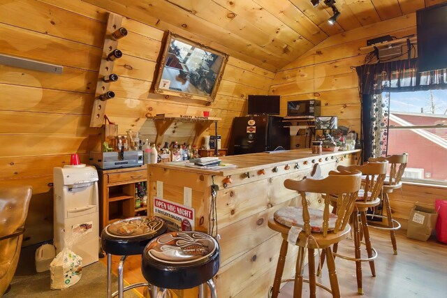 550 Ohio St, Bangor, ME 04401 - bar with wood walls, freestanding refrigerator, vaulted ceiling, and wooden ceiling