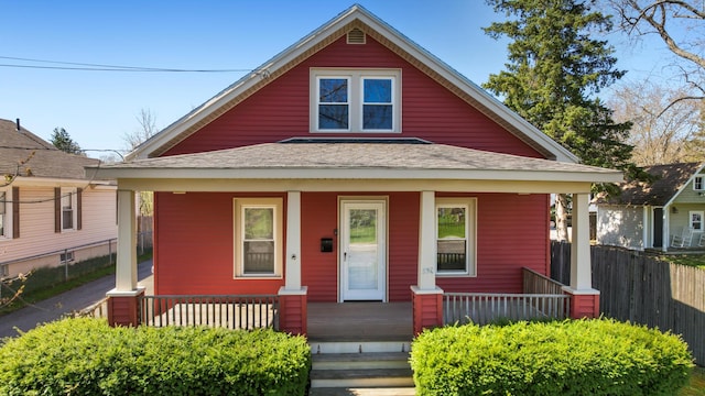550 Ohio St, Bangor, ME 04401 - bungalow-style home with roof with shingles, fence, and a porch