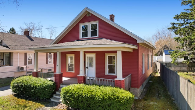 550 Ohio St, Bangor, ME 04401 - bungalow featuring fence, covered porch, a chimney, and a shingled roof