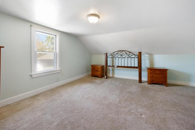 550 Ohio St, Bangor, ME 04401 - additional living space with vaulted ceiling, baseboards, and carpet flooring