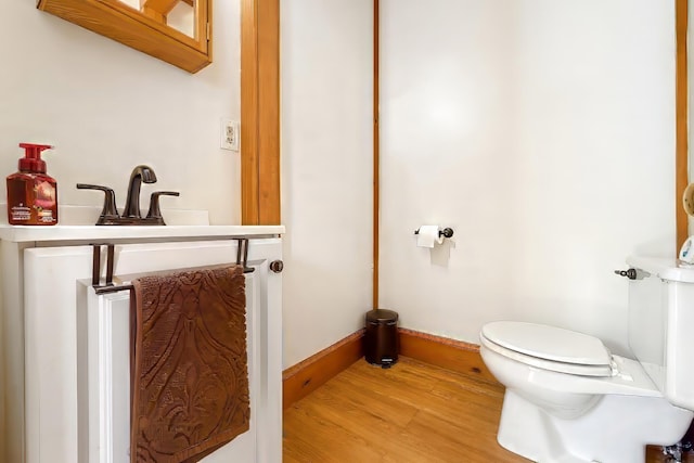 550 Ohio St, Bangor, ME 04401 - half bath featuring toilet, baseboards, and wood finished floors