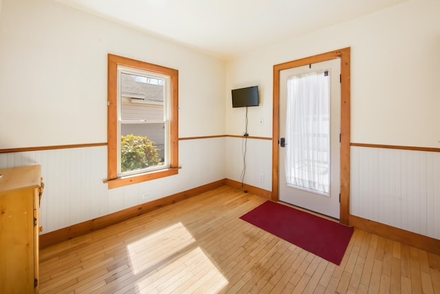 550 Ohio St, Bangor, ME 04401 - doorway with baseboards, wood-type flooring, and wainscoting