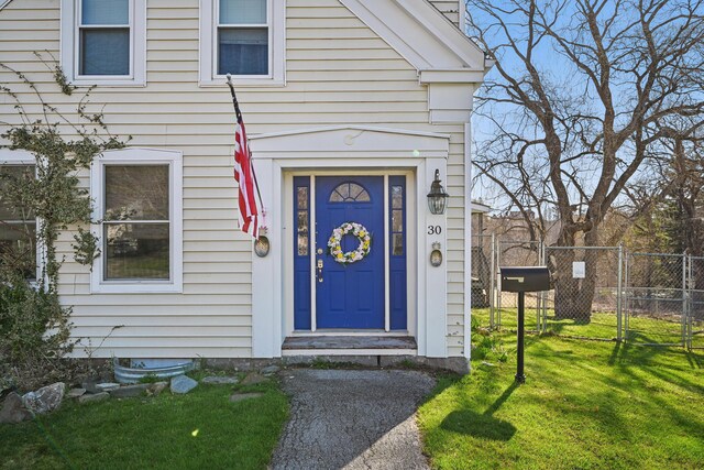 30 Pine St, Thomaston, ME 04861 - view of exterior entry with fence and a lawn