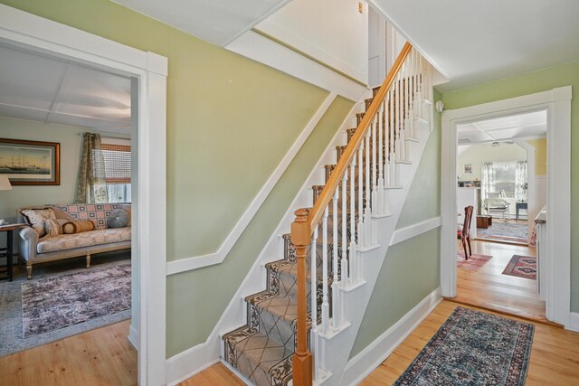 30 Pine St, Thomaston, ME 04861 - staircase with baseboards, wood finished floors, and a healthy amount of sunlight