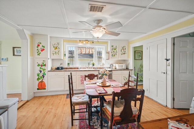 30 Pine St, Thomaston, ME 04861 - dining room with light wood finished floors, arched walkways, visible vents, and ceiling fan