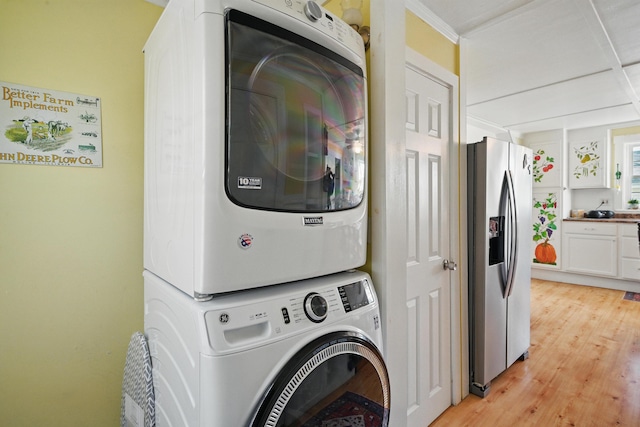 30 Pine St, Thomaston, ME 04861 - laundry room featuring stacked washer and clothes dryer, laundry area, and light wood finished floors
