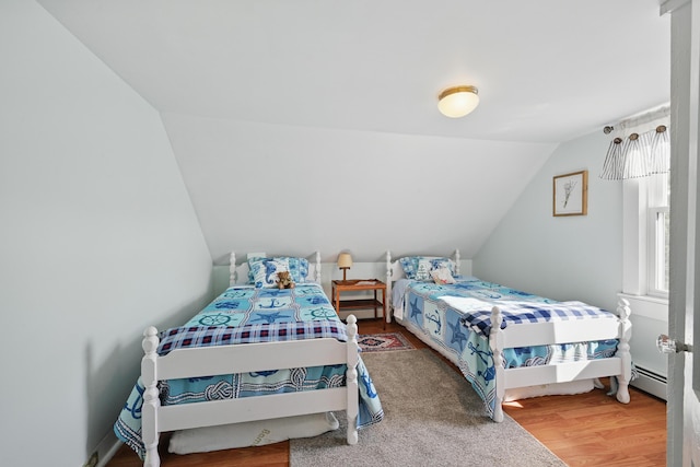 30 Pine St, Thomaston, ME 04861 - bedroom with wood finished floors, a baseboard heating unit, and lofted ceiling