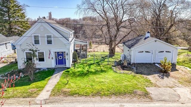 30 Pine St, Thomaston, ME 04861 - view of front of home with a front yard, a garage, an outdoor structure, a chimney, and fence