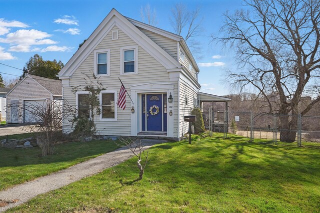30 Pine St, Thomaston, ME 04861 - view of front of house featuring a garage, fence, an outdoor structure, and a front lawn