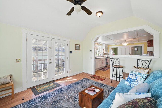 30 Pine St, Thomaston, ME 04861 - living room featuring arched walkways, ceiling fan, light wood finished floors, baseboards, and french doors