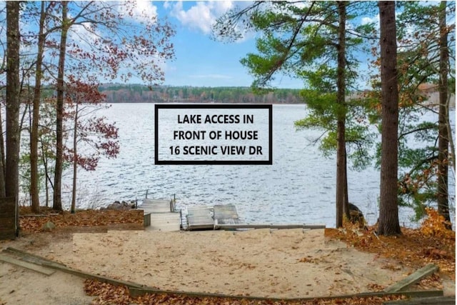 community / neighborhood sign featuring a water view