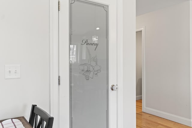 room details featuring baseboards and wood finished floors