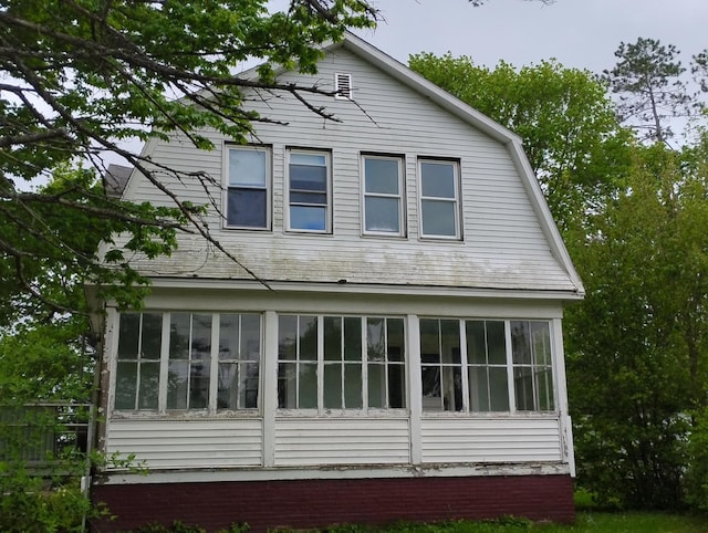 105 Broadway, Baileyville, ME 04694 - view of side of property with a sunroom