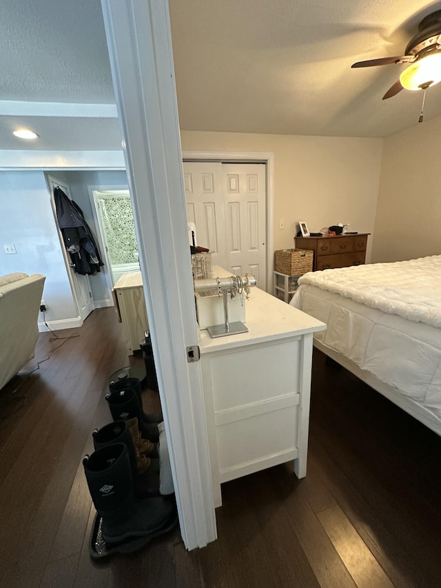bedroom featuring dark wood finished floors and a ceiling fan