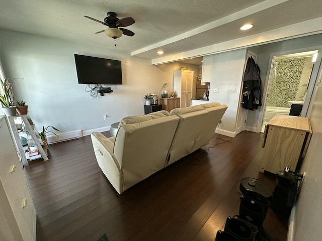 living area with baseboard heating, a ceiling fan, baseboards, dark wood-type flooring, and recessed lighting