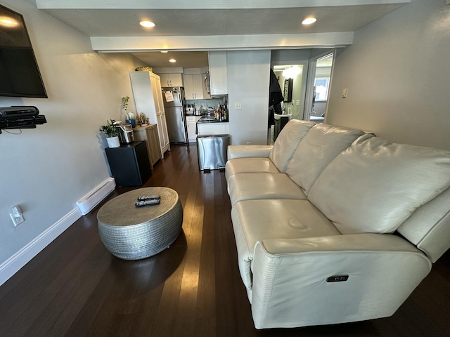 living area with a baseboard heating unit, baseboards, dark wood-style flooring, and recessed lighting