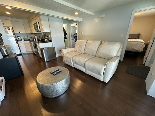 living area featuring recessed lighting and dark wood-style floors