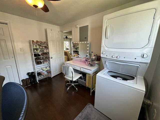 clothes washing area with dark wood-style floors, stacked washer and clothes dryer, a ceiling fan, and laundry area