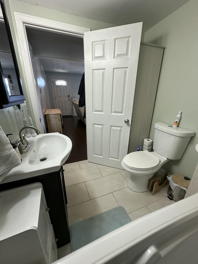 bathroom featuring tile patterned floors, toilet, and vanity