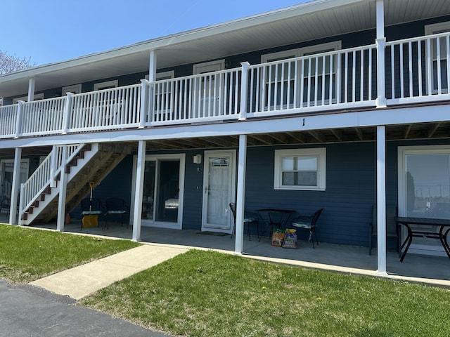 back of house featuring a yard and a patio