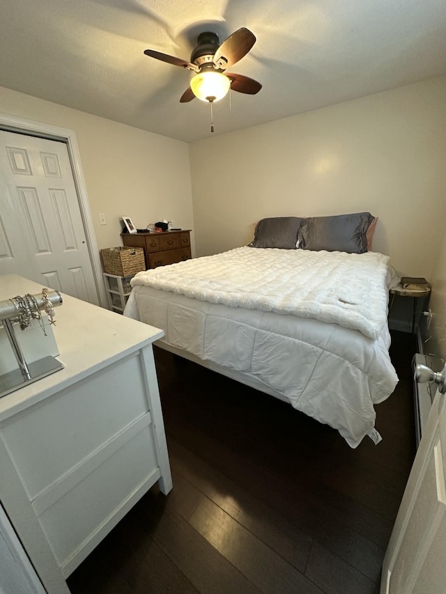 bedroom with ceiling fan and dark wood-type flooring