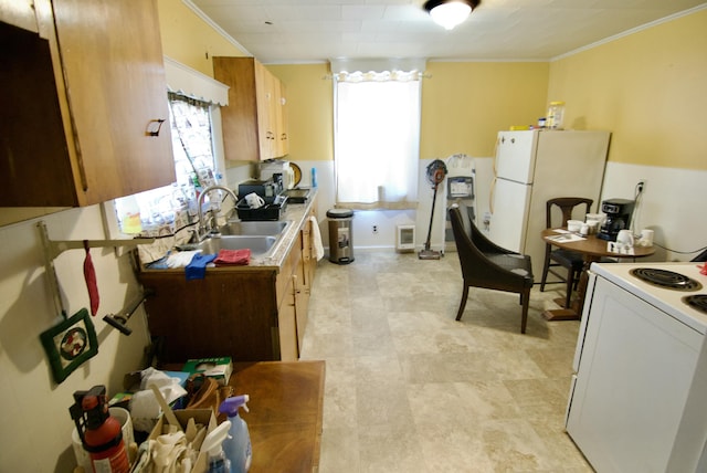 kitchen featuring ornamental molding, light countertops, a sink, and white appliances