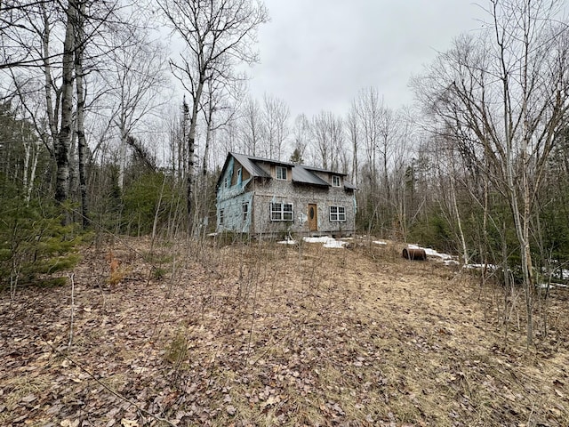 exterior space featuring a wooded view