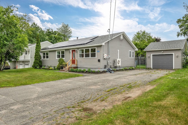 102 New Hampshire St, Millinocket, ME 04462 - view of front of home featuring a garage, driveway, roof mounted solar panels, a front lawn, and an outdoor structure