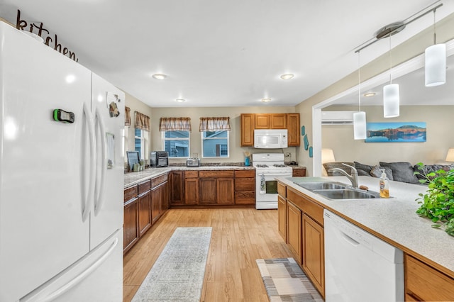 102 New Hampshire St, Millinocket, ME 04462 - kitchen with white appliances, light wood-style flooring, light countertops, and pendant lighting