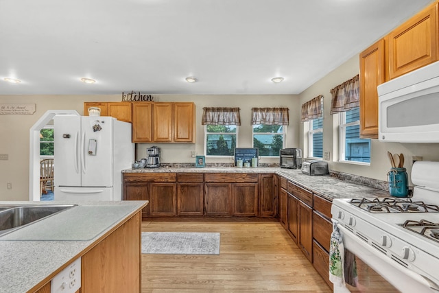 102 New Hampshire St, Millinocket, ME 04462 - kitchen featuring white appliances, light wood-style floors, light countertops, brown cabinetry, and recessed lighting
