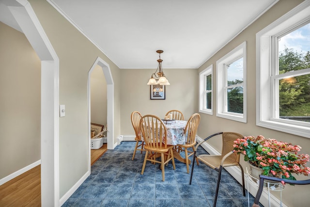 102 New Hampshire St, Millinocket, ME 04462 - dining room with healthy amount of natural light, baseboard heating, crown molding, and arched walkways