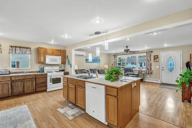 102 New Hampshire St, Millinocket, ME 04462 - kitchen with white appliances, open floor plan, an AC wall unit, light wood-style flooring, and an island with sink