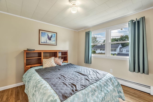 102 New Hampshire St, Millinocket, ME 04462 - bedroom featuring baseboard heating, crown molding, and wood finished floors