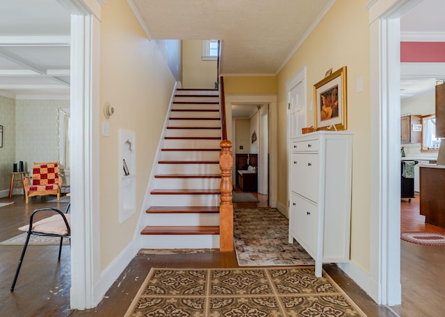 stairway featuring crown molding, baseboards, and wood finished floors