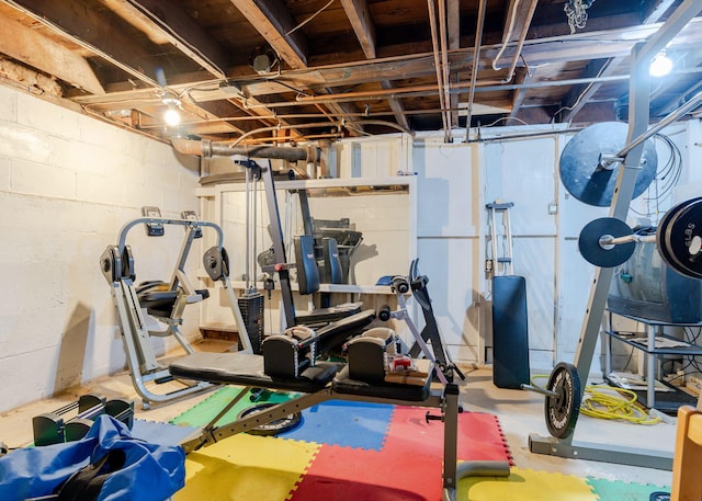 workout area with concrete block wall
