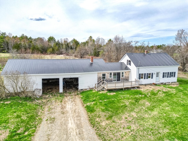 93 Pond Rd, Albion, ME 04910 - rear view of property featuring dirt driveway, a wooden deck, a chimney, metal roof, and a lawn