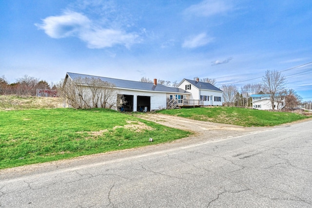 93 Pond Rd, Albion, ME 04910 - bungalow with driveway, metal roof, a front lawn, and a garage