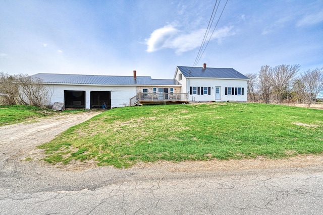 93 Pond Rd, Albion, ME 04910 - ranch-style home with a front lawn, metal roof, driveway, a chimney, and a deck