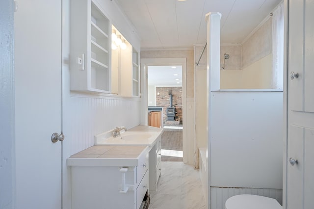 93 Pond Rd, Albion, ME 04910 - bathroom with marble finish floor, shower / bathing tub combination, toilet, vanity, and a wood stove