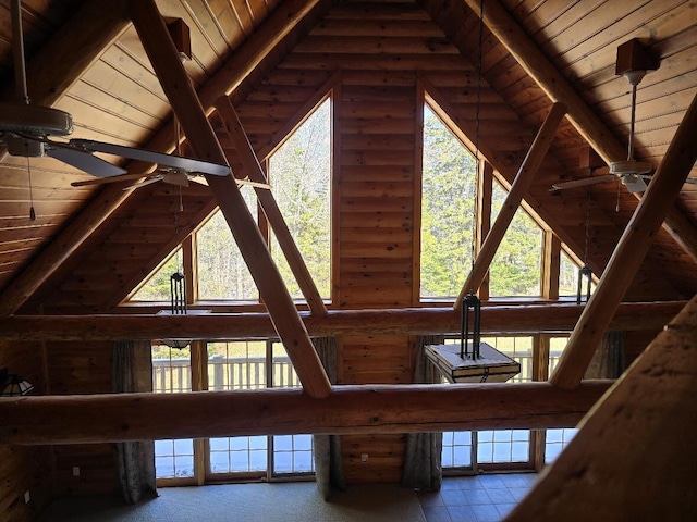 room details with ceiling fan, rustic walls, and wood ceiling