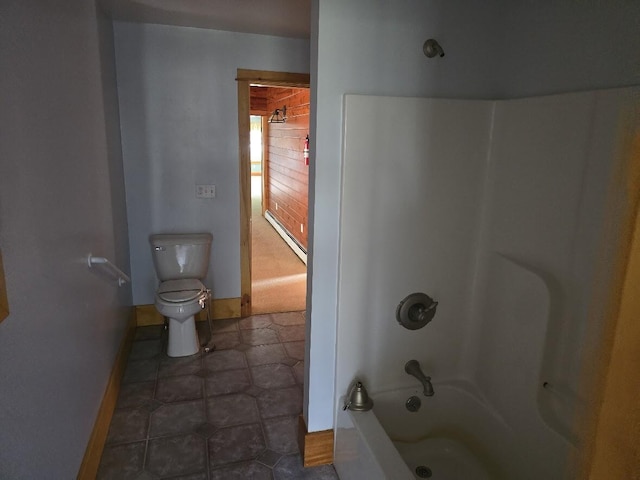 bathroom with toilet, shower / tub combination, tile patterned floors, and baseboards
