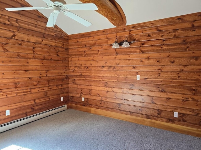 unfurnished room with a ceiling fan, a baseboard heating unit, wood walls, and carpet